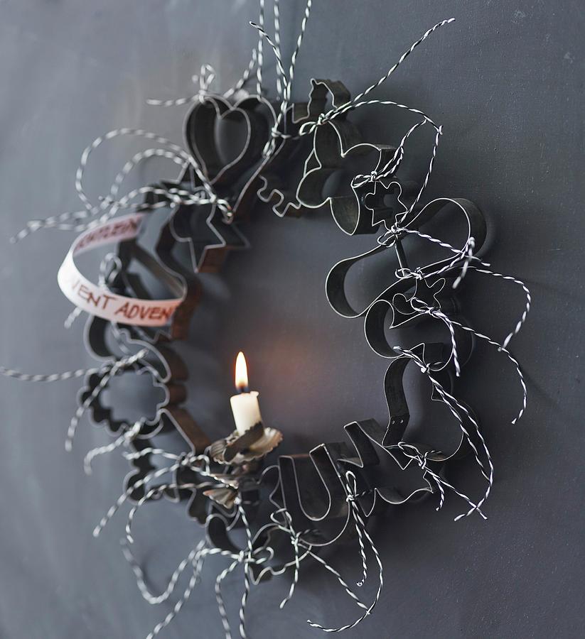 Advent Wreath Made From Pastry Cutters And A Single Candle Photograph by Andreas Hoernisch