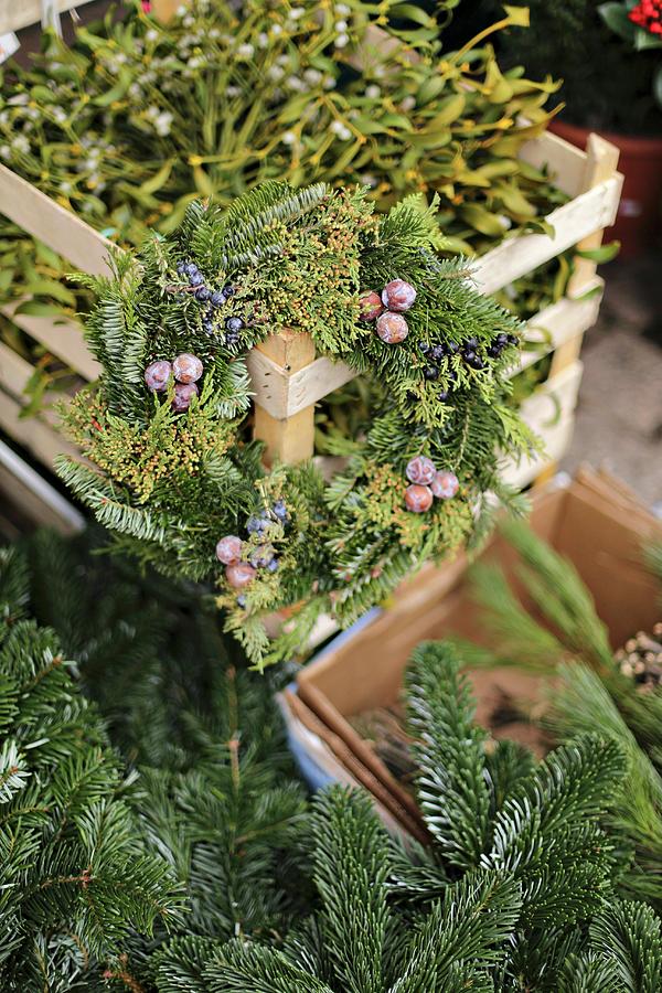 Advent Wreath Of Fir Branches On Crate Of Mistletoe Photograph by Alexandra Panella