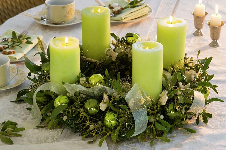 Advent Wreath Of Mistletoe And Spruce With Green Candles Photograph by Friedrich Strauss