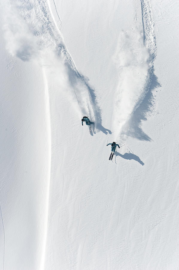 Aerial View Of Two Skiers Skiing Photograph by Creativaimage