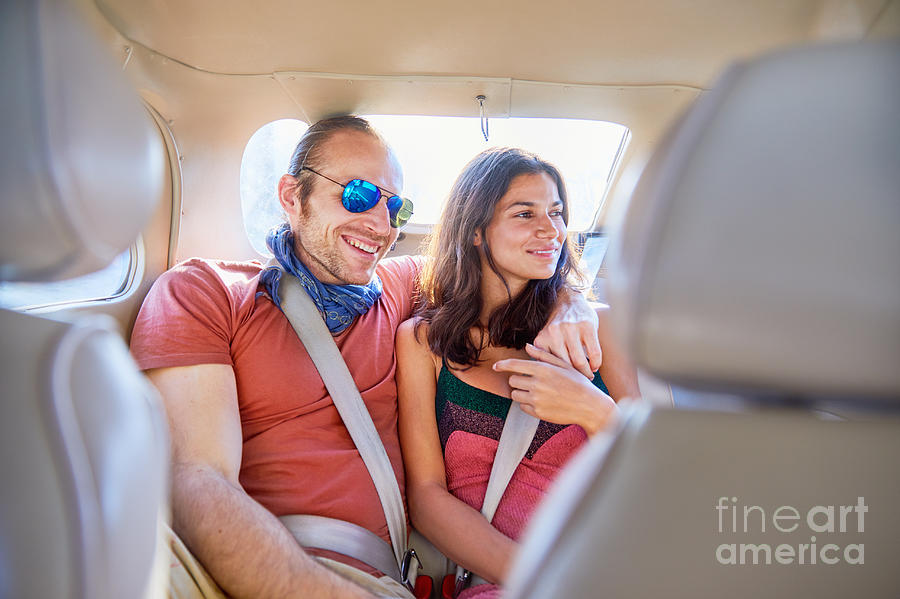 Affectionate Couple Riding In Back Seat Of Car Photograph By Caia Image