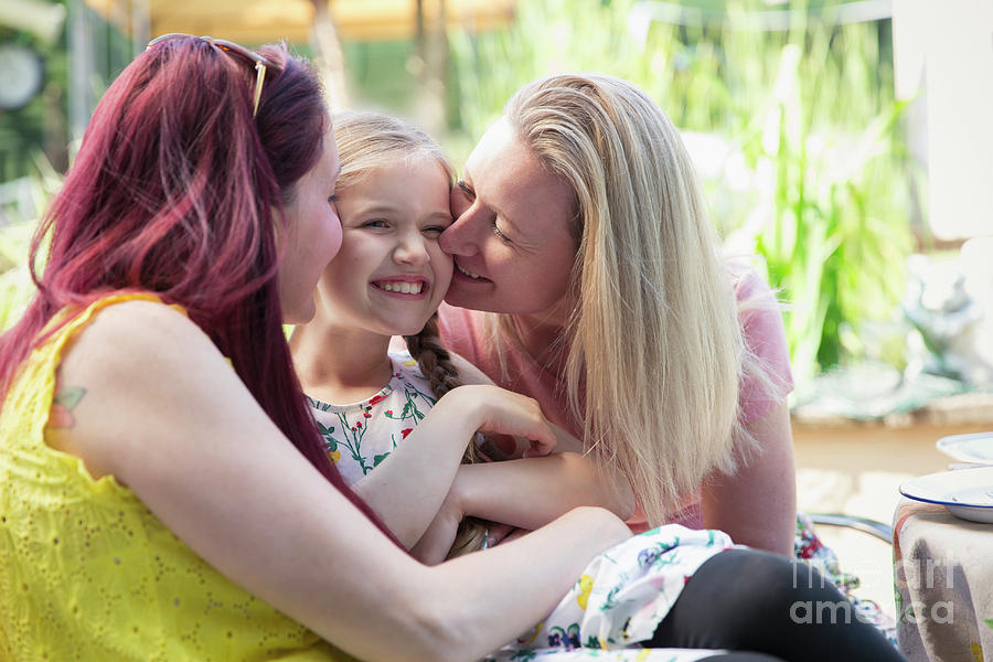 Affectionate Lesbian Couple Kissing Daughter Photograph By Caia Image