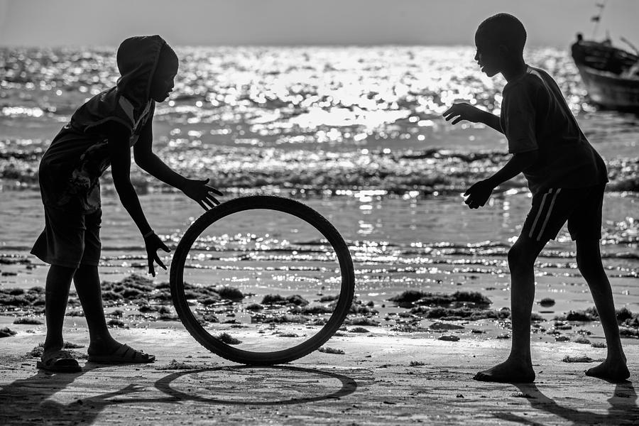 Africa Kids Playing With Old Wheel Photograph by Milton Louiz