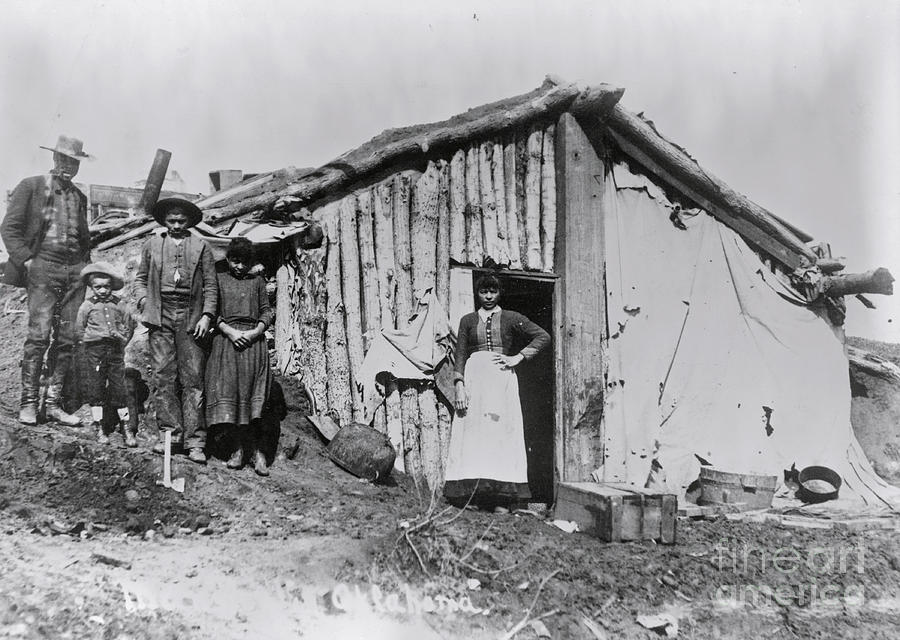 African American Family And Log Cabin Photograph by Bettmann