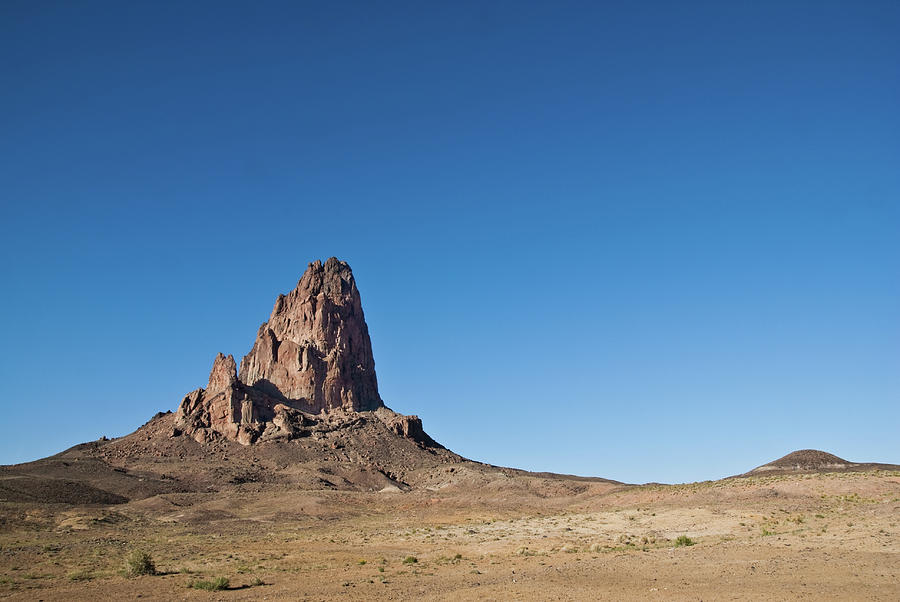 Agathla Peak And Desert Photograph by Jeffgoulden