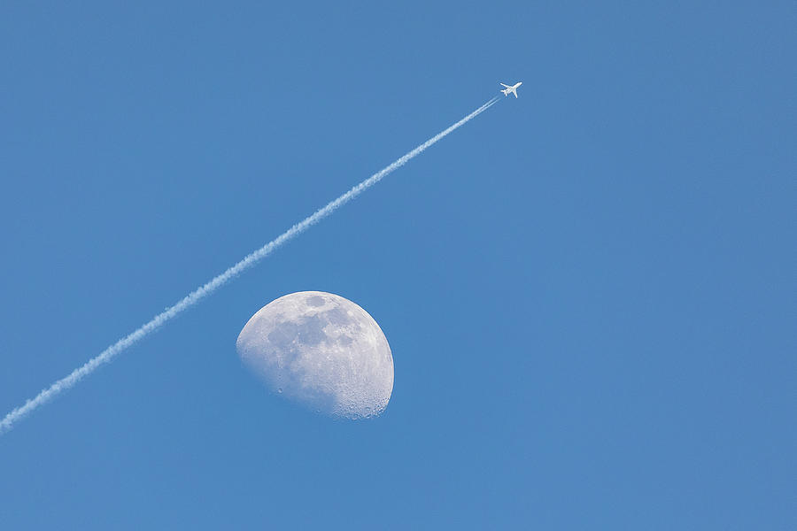 Airplane Does a Moon Flyby Photograph by Tony Hake