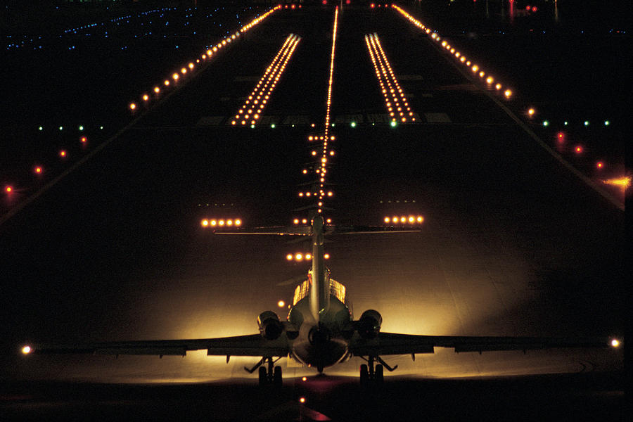 Airplane On Runway At Night Photograph by Comstock