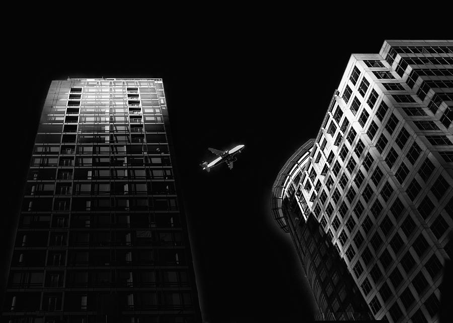 Airplane Over Buildings Photograph by Ken Liang