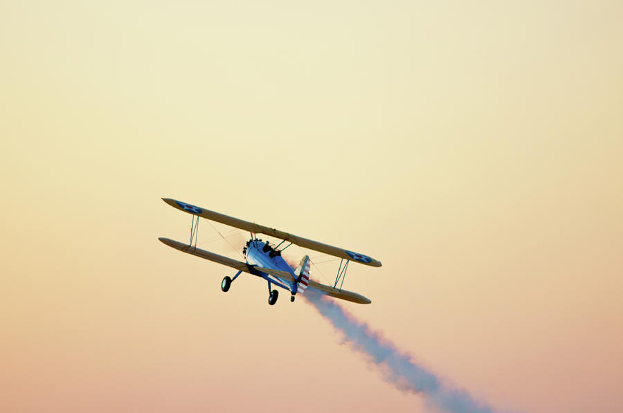 Sunset Photograph - Airshow Smoke Trail At Sunset by Jim Mckinley