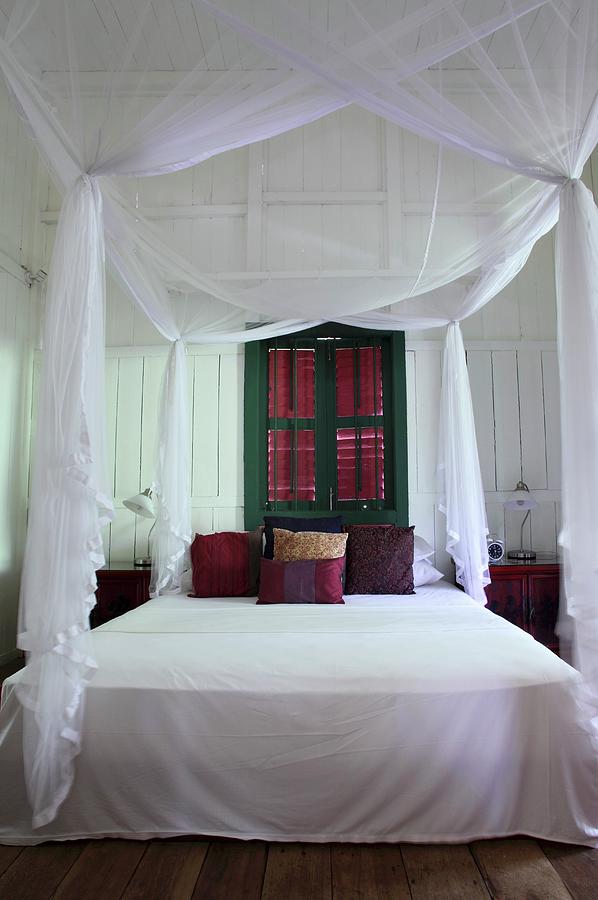 Airy, White Fabric Over Canopied Bed In Front Of Green-painted Window With Closed Shutters Photograph by Steven Morris