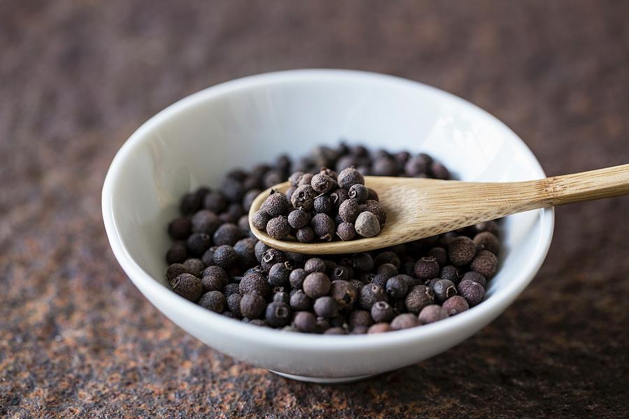 Allspice With A Wooden Spoon In A Bowl Photograph by Nicole Godt