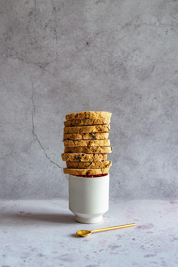 Almond And Orange Biscotti Stacked On Cup Photograph by Hein Van Tonder