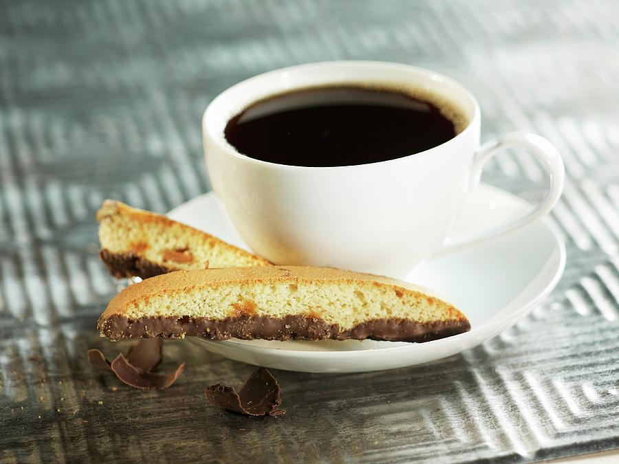 Almond Biscotti With Chocolate Next To A Cup Of Coffee Photograph by Brenda Spaude