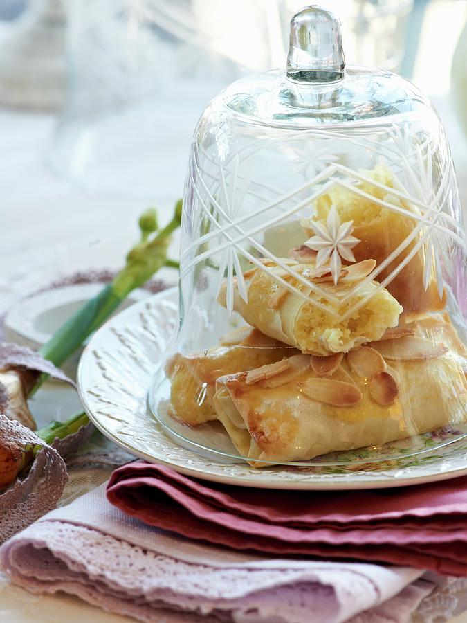 Almond Filo Pastries Under A Bell Jar Photograph by Hannah Kompanik