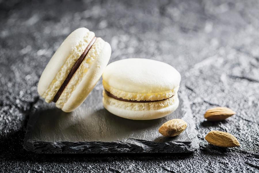 Almond Macaroons On A Black Stone Photograph by Shaiith