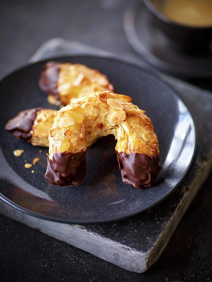 Almond Pastries Coated In Chocolate Photograph by Peter Rees
