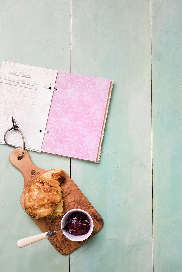 Almond Pastries With Jam On A Wooden Board Next To A Book Photograph by Great Stock!