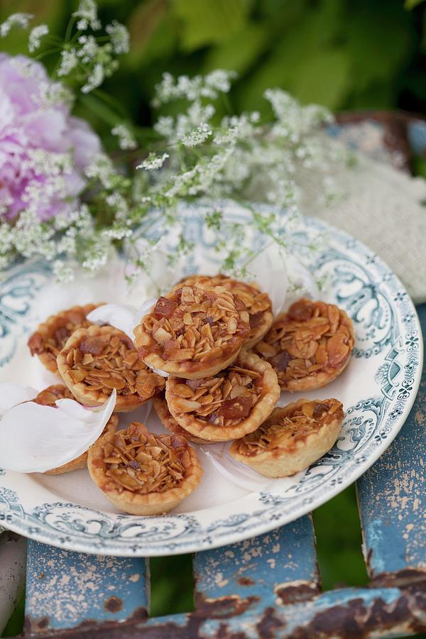 Almond Tarts And Chervil Flowers On Vintage-style Plate Photograph by Martina Schindler
