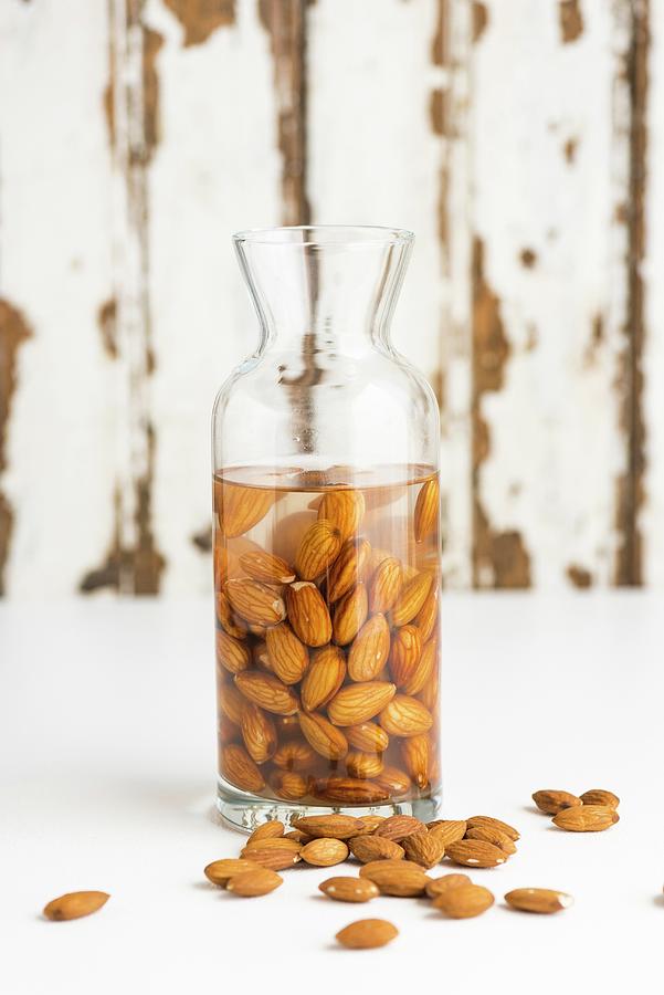 Almonds Being Softened To Make Almond Milk Photograph by Hein Van Tonder