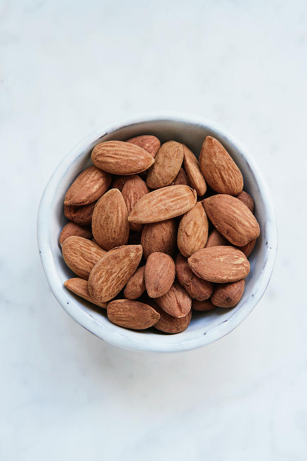 Almonds In A Ceramic Bowl Photograph by Brigitte Sporrer