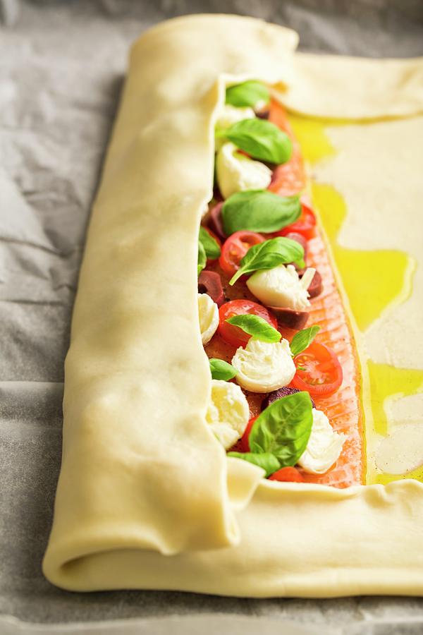 Alpine Salmon With Tomatoes, Mozzarella And Basil Being Wrapped In Puff Pastry Photograph by Sandra Krimshandl-tauscher