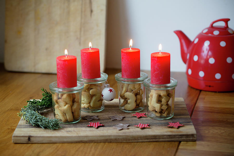Alternative Advent Wreath Made From Candles On Mason Jars Containing Biscuit Numbers 1-4 Photograph by Iris Wolf