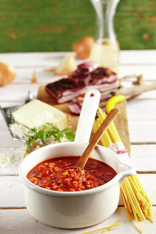 Amatriciana Sauce With Bacon, Cheese, Pasta And Wine On A Table Photograph by Teubner Foodfoto