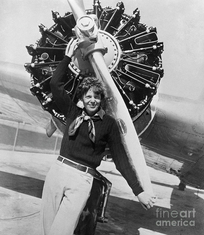 Amelia Earhart Posing Before Her Planes Photograph by Bettmann