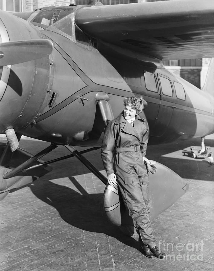 Amelia Earhart Shown With Her Airplane Photograph by Bettmann
