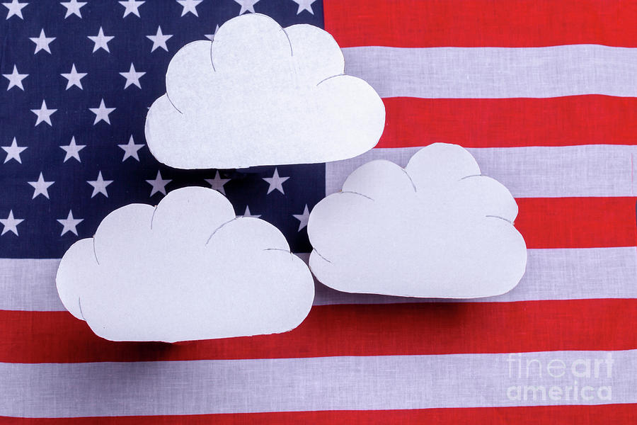 American flag with three white clouds floating above Photograph by Simon Bratt
