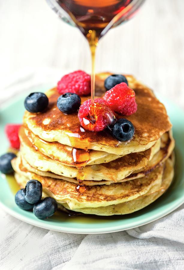 American-style Pancakes With Fresh Berries And Maple Syrup Photograph by Lucy Parissi