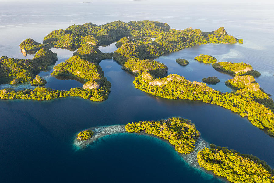 Nature Photograph - An Aerial View Of Islands In Raja by Ethan Daniels