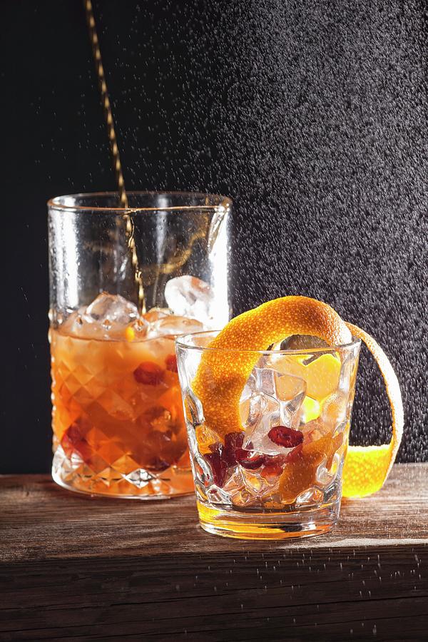 An Alcoholic Cocktail Made With Fruits And Orange Zest Photograph by Danny Lerner