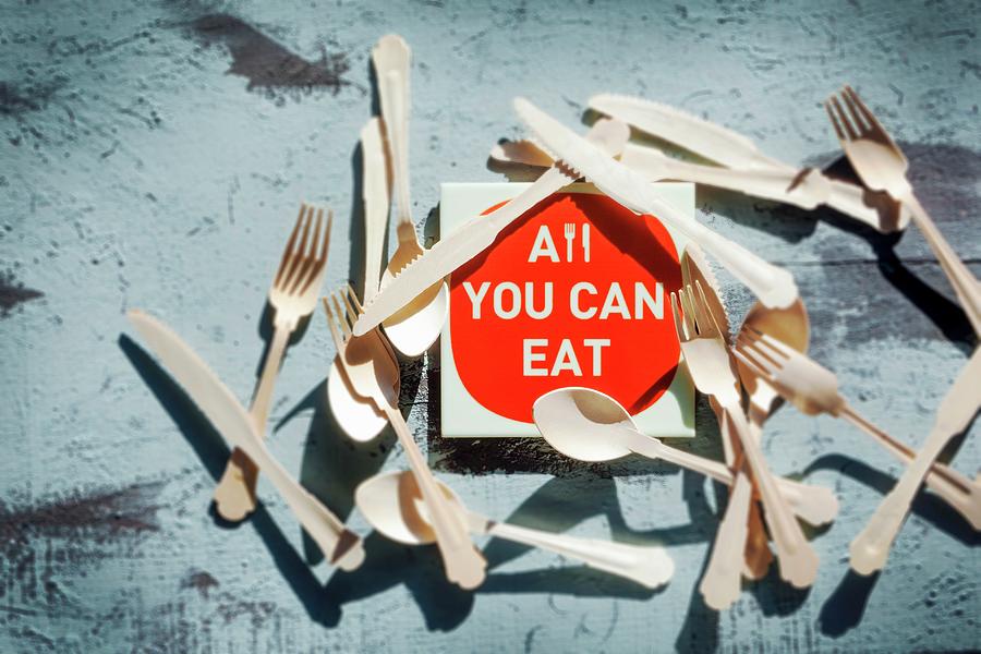 An all You Can Eat Sign Surrounded By Cutlery Photograph by Birgit Twellmann