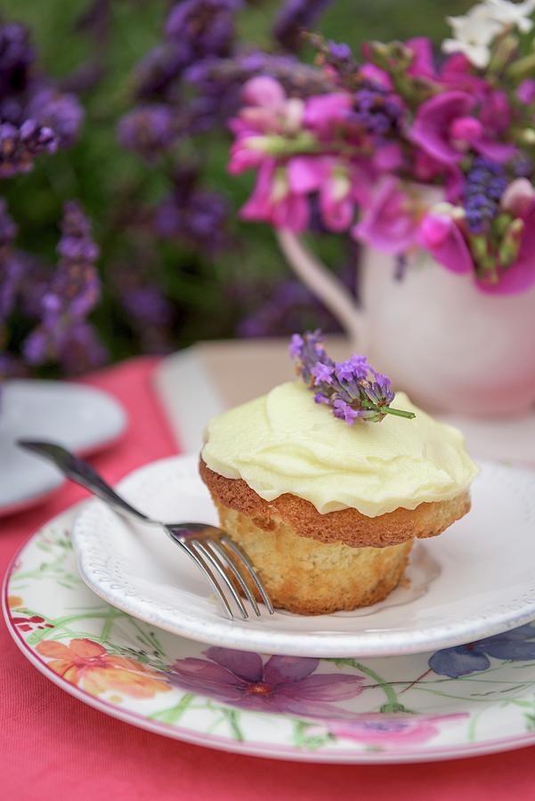 An Almond Cupcake With Lavender Cream On A Summer Table Outside Photograph by Winfried Heinze