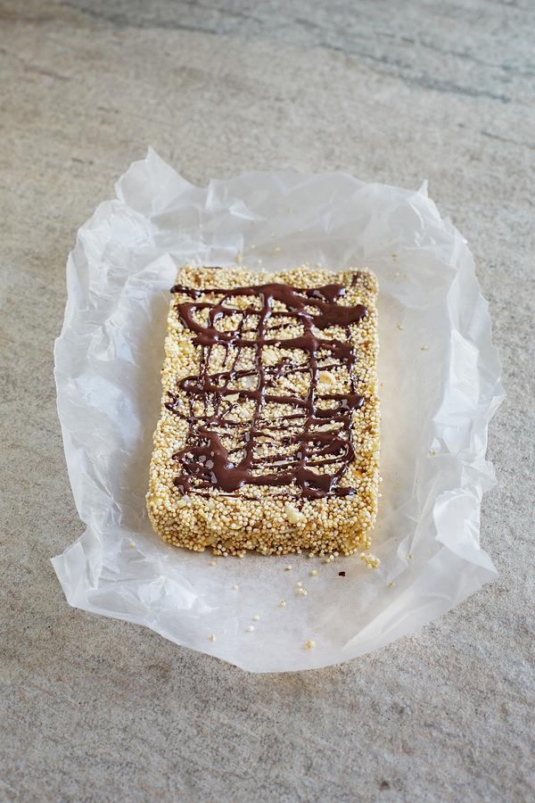An Amaranth Bar With Chocolate And Cashew Nuts On A Piece Of Paper Photograph by Tina Engel