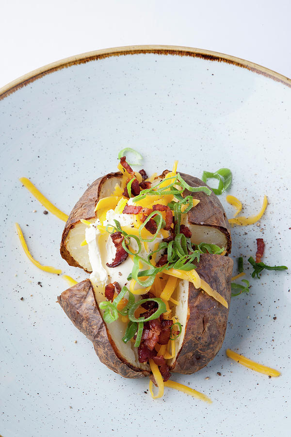 An American Baked Potato With Cheddar And Bacon Photograph by Michael Wissing