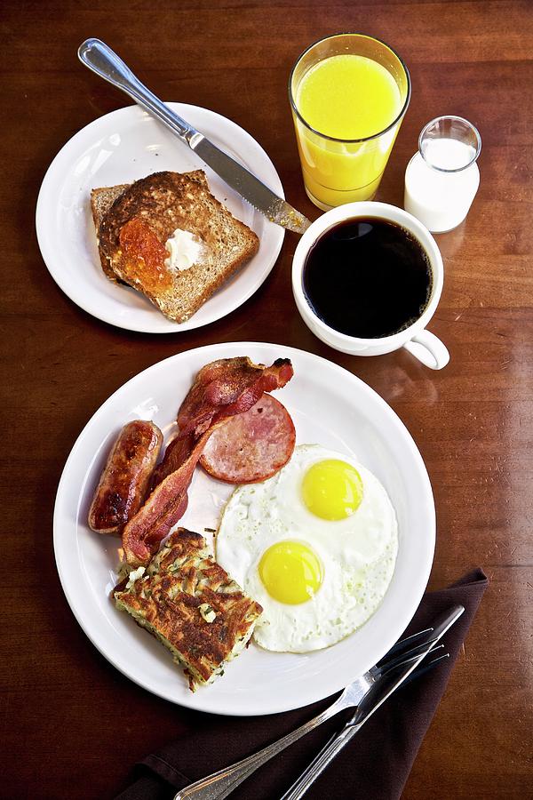 An American Breakfast With Two Fried Eggs, Sausage And Bacon Photograph by Andre Baranowski