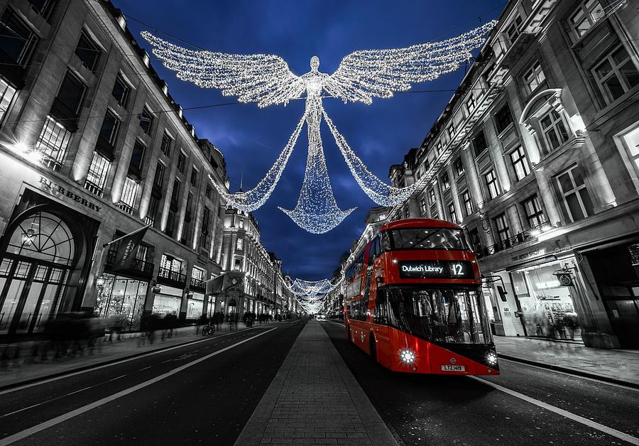 An Angel Christmas Decoration And A Red Bus In London, England. Photograph