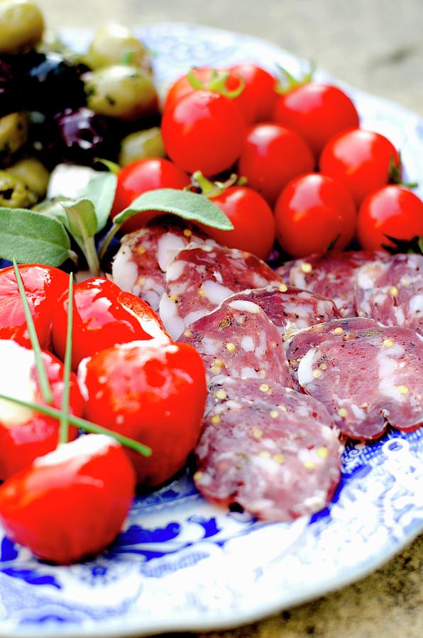 An Antipasti Platter With Sliced Salami, Cherry Tomatoes, Pimientos Filled With Ricotta And Olives Photograph by Jamie Watson
