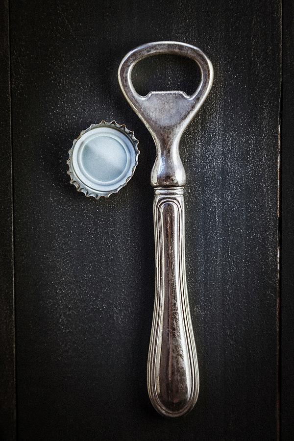 An Antique Bottle Opener And Bottle Top Photograph by Younes Stiller