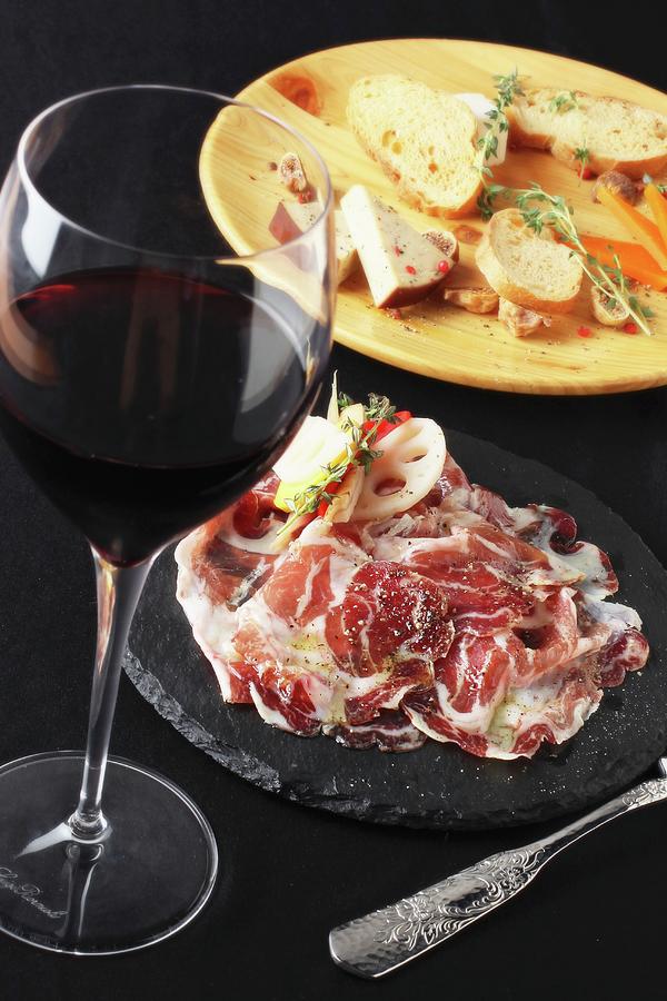 An Appetiser Platter With Raw Ham And A Glass Of Red Wine Photograph by Yuichi Nishihata Photography