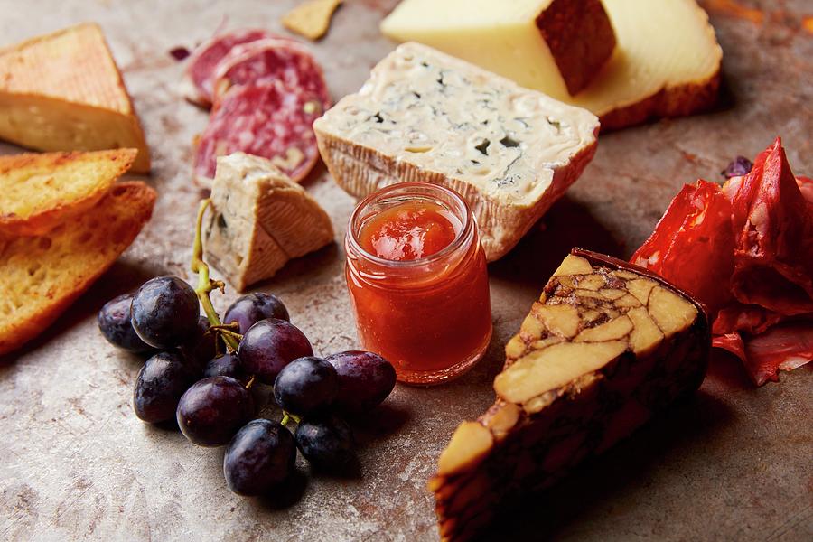 An Appetizer Platter With Different Types Of Cheese, Salami, Grapes And Bread Photograph by Liv Friis