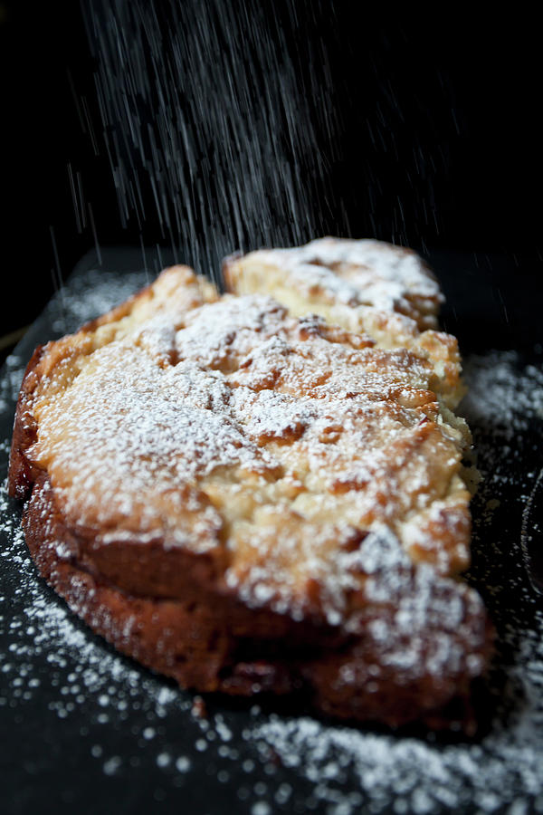 An Apple Cake On A Black Board, Being Dusted With Powdered Sugar Photograph by Ryla Campbell