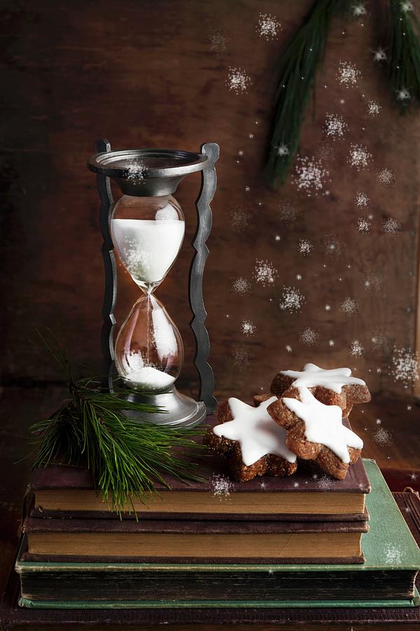 An Arrangement Featuring An Antique Sand Timer And Chocolate And Nut Christmas Biscuits Photograph by Atelier Hmmerle