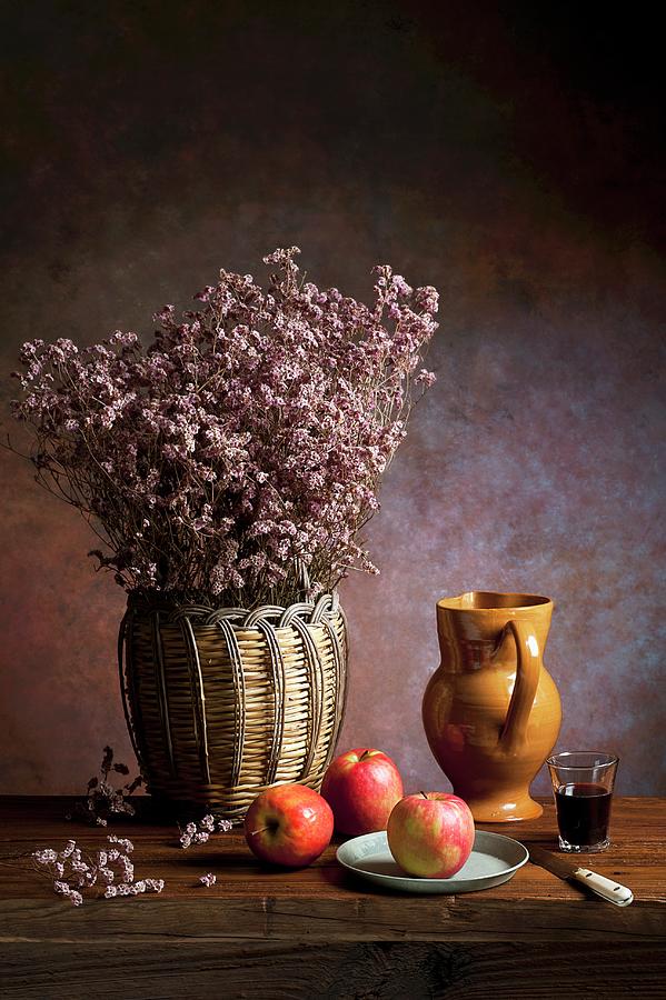 An Arrangement Featuring Apples, Dried Flowers, An Earthenware Jug, Wine And A Knife Photograph by Elio Lombardo