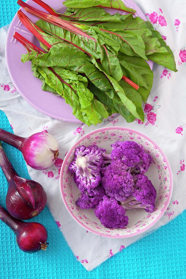 An Arrangement Of Beetroot Leaves, Red Onion And Purple Cauliflower Photograph by Studio Lipov
