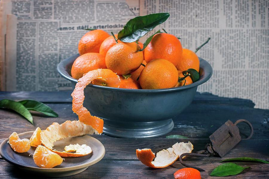 An Arrangement Of Clementines In A Metal Bowl On A Rustic Wooden Table Photograph by Natasha Breen