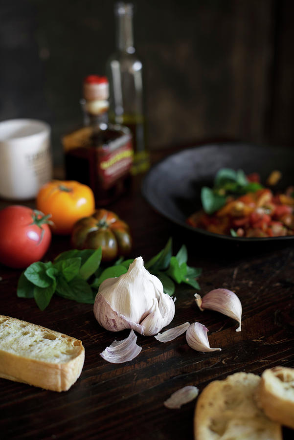 An Arrangement Of Garlic, Tomatoes, Basil And Bread Photograph by Justina Ramanauskiene