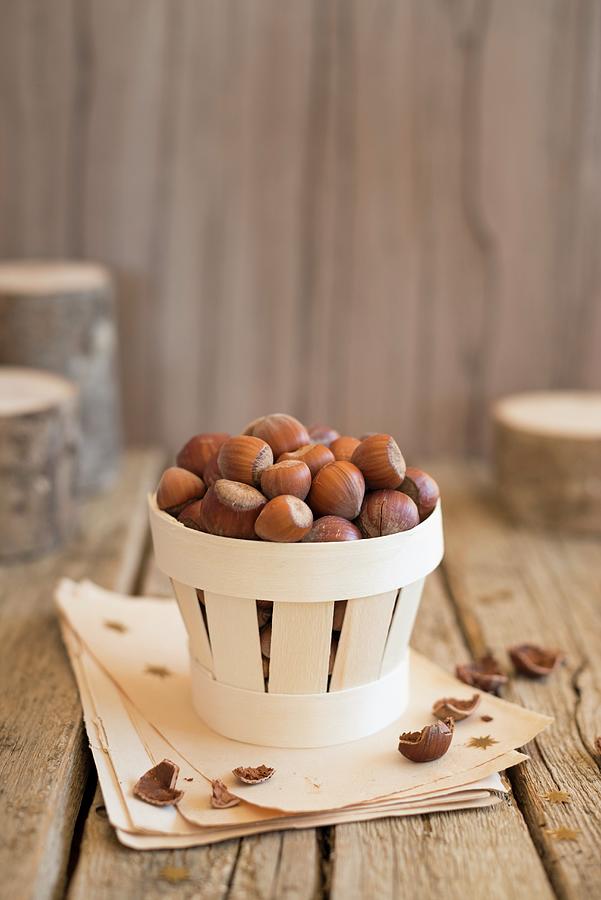 An Arrangement Of Hazelnuts In A Wooden Basket Photograph by Sonia Chatelain